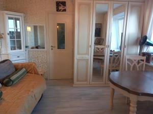 a living room with a couch and a table at Amber Beach Apartment in Narva-Jõesuu