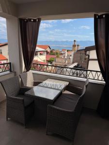 a balcony with a table and chairs and a view of the ocean at Luxury Blue Sky in Vir