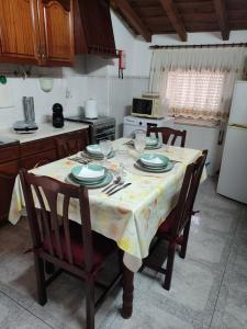 a kitchen with a table with plates and glasses on it at Casa da Cristina in Nazaré