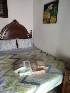 a bedroom with a bed with a blanket on it at Casa da Cristina in Nazaré +17 photos