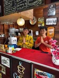 two men standing behind a counter in a coffee shop at The Ci Dwi Resort in Cicadas +36 photos