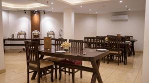 a dining room with a table and chairs at The Chapter Hotel, Vasant Kunj in New Delhi