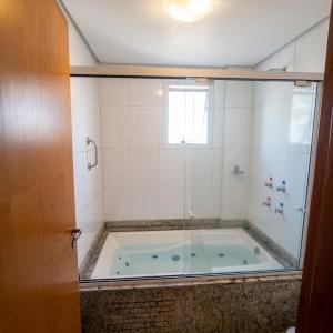 a bath tub in a bathroom with a glass door at Hotel Aguadero in Passo Fundo +45 photos