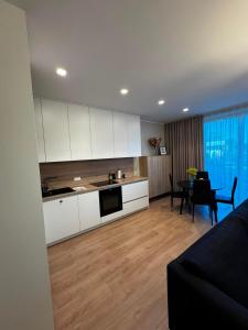 a living room with a kitchen and a dining room at Cozy corner89, private parking in Valmiera
