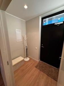 a room with a door with a bench and a window at Cozy corner89, private parking in Valmiera +8 photos