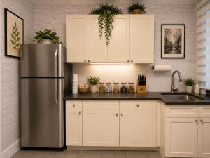 a kitchen with a stainless steel refrigerator and white cabinets at Lemon Vibes room in Guesthouse in New York