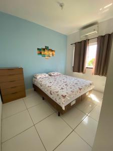 a bedroom with a bed and a dresser in it at Refúgio da Praia in Caucaia