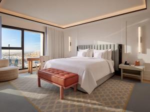 a bedroom with a large white bed and a chair at The View Rabat in Rabat +88 photos