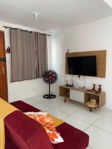 a bedroom with a flat screen tv on the wall at Refúgio da Praia in Caucaia