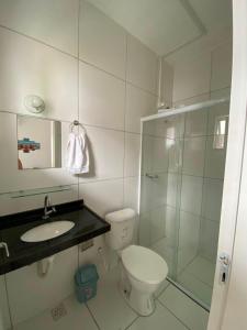 a bathroom with a toilet and a sink and a shower at Refúgio da Praia in Caucaia +4 photos