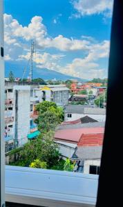 a view of a city from a window at The Yak Cozy Chiang Mai in Chiang Mai +124 photos
