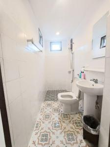 a bathroom with a toilet and a sink at The Yak Cozy Chiang Mai in Chiang Mai