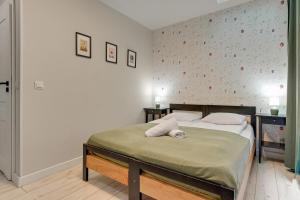 a bedroom with a bed with two towels on it at WaterLane Island Hostel&Apartments in Gdańsk