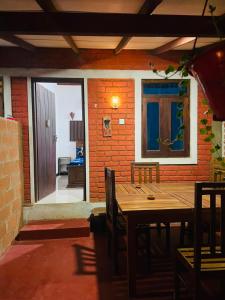 a dining room with a wooden table and chairs at Angry birds rooms in Habarana