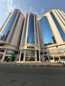 a large building with many windows on a street at Vivian AL Shasha in Mecca