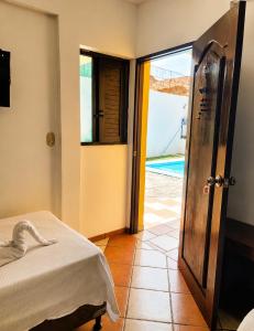 a bedroom with a bed and a view of a pool at Hotel Valeria in Granada