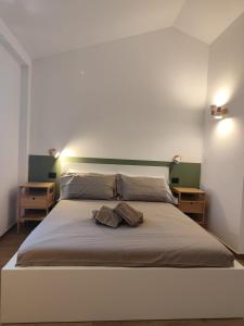 a bedroom with a large bed with two pillows on it at Agriturismo L'Olivastro in Pollutri