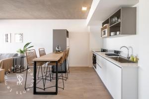 a kitchen with a sink and a table with chairs at Top Rentals Nuñez in Buenos Aires