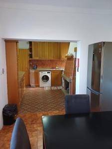 a kitchen with wooden cabinets and a stainless steel refrigerator at Serra Viva in Cortes do Meio +14 photos