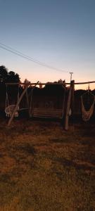a couple of hammocks sitting in a field at Raj nad Narwią in Zatory