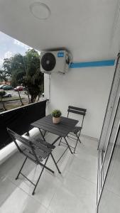 a table and chairs on a balcony with a camera at Studio cosy Ducos in Ducos