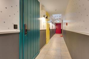 a hallway with a green door and a hallway with yellow and pink at WaterLane Island Hostel&Apartments in Gdańsk +48 photos