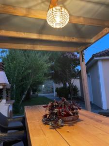 a wooden table with a light on top of it at Anabelis studios & apartments in Katelios