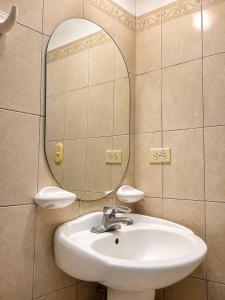 a bathroom with a sink and a mirror at Hotel Valeria in Granada +18 photos