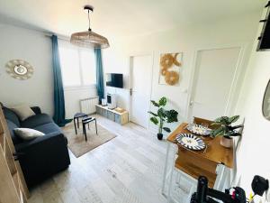 a living room with a couch and a table at Studio centre ville in Concarneau