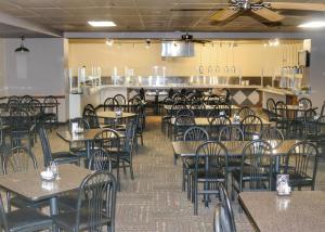 an empty dining room with tables and chairs at Ohkay Hotel Casino in San Juan Pueblo