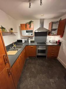 a kitchen with a sink and a stove at Aphrodite in Birmingham
