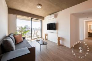 a living room with a couch and a tv at Top Rentals Nuñez in Buenos Aires