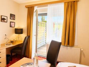 an office with a desk and a window with a balcony at Ratscher Landhaus in Ratsch an der Weinstraße