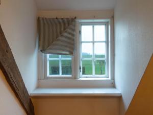 a window in a room with a blind at Ferienwohnung Hasenkate I - Boldevitzer Rügenkaten in Parchtitz +7 photos