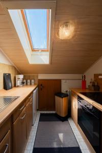 a kitchen with a skylight in the ceiling of a kitchen at Ferienwohnung Kampenwand in Bad Endorf