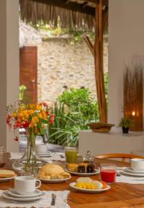 a table with plates of food on top of it at Villa Alegria - La Villa Group in Jericoacoara