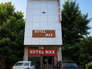 a hotel may with cars parked in front of it at HOTEL MAX - In Budget & Comfortable Rooms - For Corporates, Couples, Families Near HMV, DAV, Grain Market, Workshop Chowk in Jalandhar