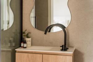 a bathroom with a sink and a mirror at Leeuwenhof Suites in Antwerp +19 photos