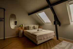 a bedroom with a large bed and a window at Leeuwenhof Suites in Antwerp