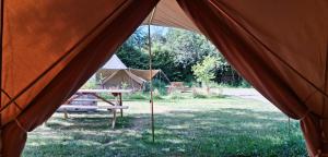 a tent with a picnic table in a field at Tente équipée in Waimes