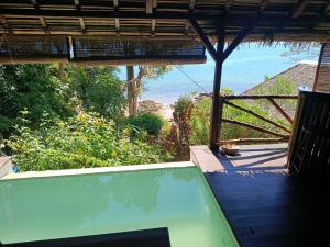 a view of the beach from a house with a swimming pool at Manta be à Nosy Komba in Ampangorinana