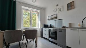 a kitchen with a table and chairs and a window at Apartament BIELSKA 26 in Płock