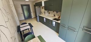 a kitchen with green cabinets and a counter top at Drago 48 in Oltre il Colle