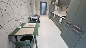 a room with tables and chairs in a kitchen at Drago 48 in Oltre il Colle +9 photos