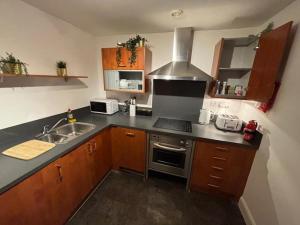 a kitchen with a sink and a stove at Aphrodite in Birmingham +13 photos