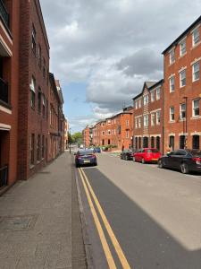 a city street with cars parked on the street at Aphrodite in Birmingham