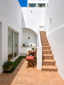 a staircase leading up to a house with a table at Casa Longa Faro Entire House - Plunge Pool and Terrace in Faro