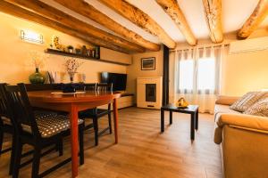 a living room with a table and a couch at Casa Rural LA COSTANILLA in Lituénigo +18 photos