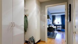a hallway with a door leading to a dining room at Apartment in Skarholmen Stockholm 206 in Stockholm +2 photos