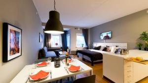 a living room with a bed and a table in a room at Apartment in Skarholmen Stockholm 206 in Stockholm